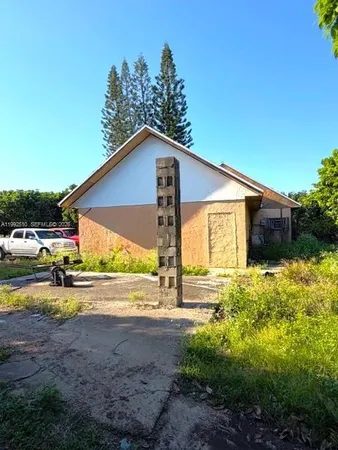 a view of a house with backyard and sitting area