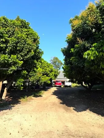 a view of street with with a yard