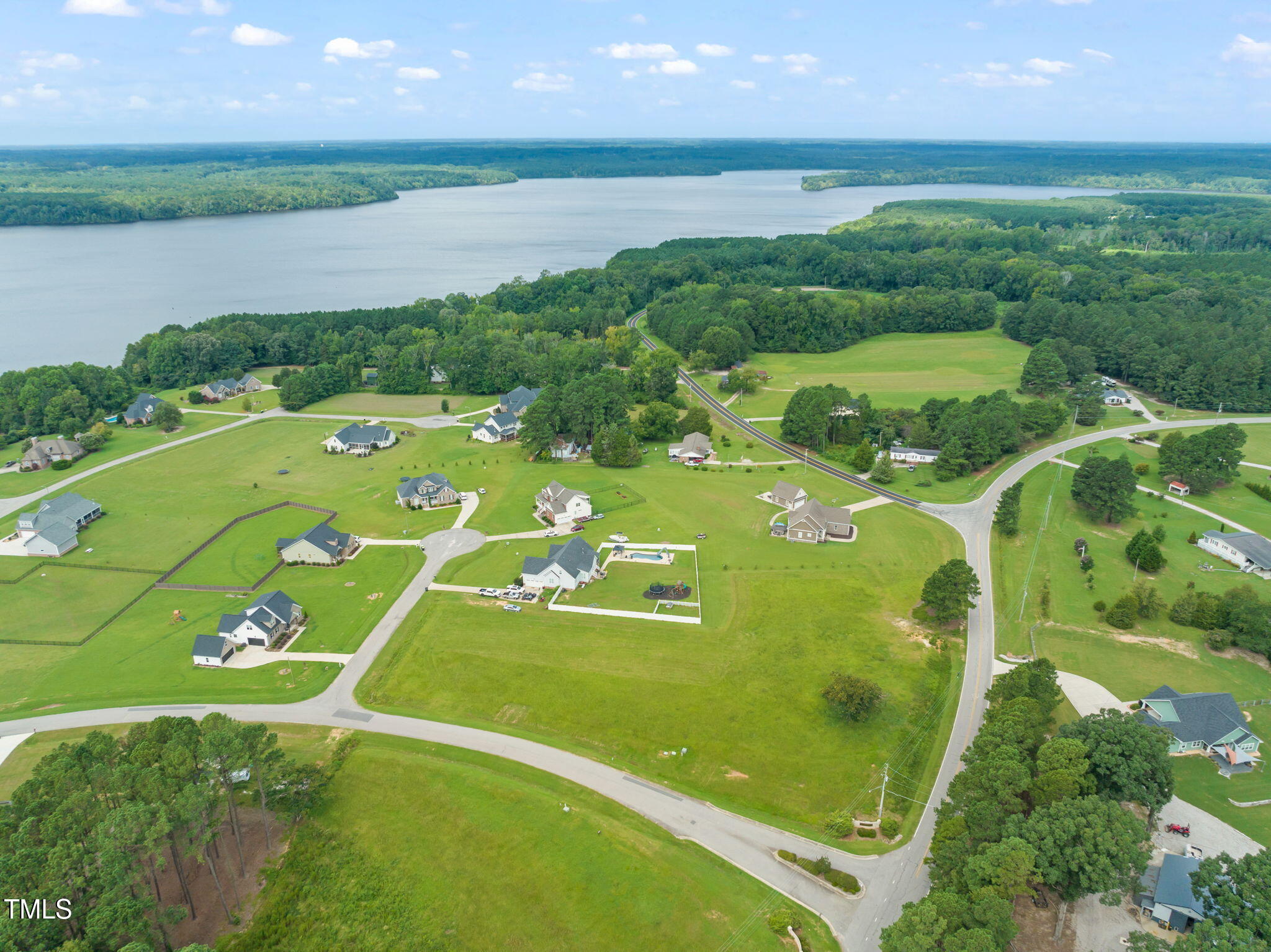 a view of a golf course with lawn chairs and a yard