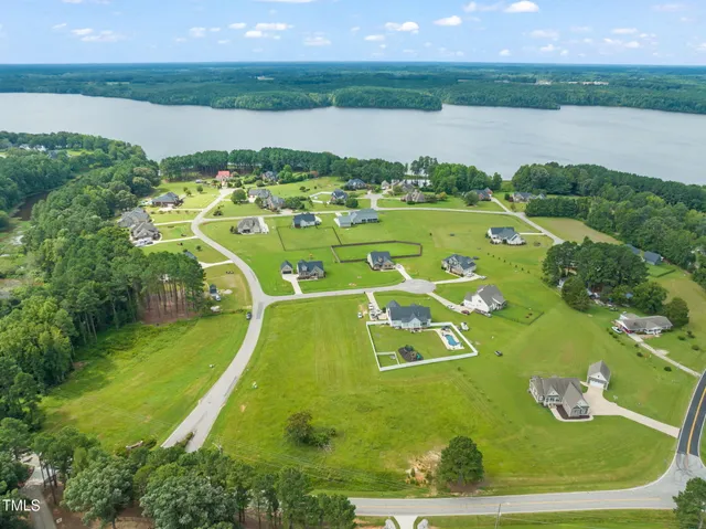 an aerial view of a golf course with a lake view