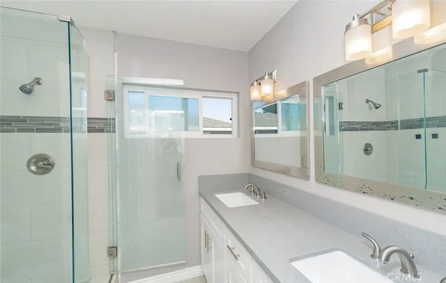 a bathroom with a granite countertop sink mirror and double