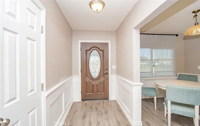 a view of a hallway with entryway wooden floor and dining room view