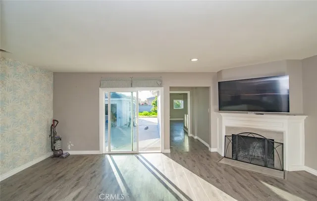 a living room with a fireplace and a flat screen tv
