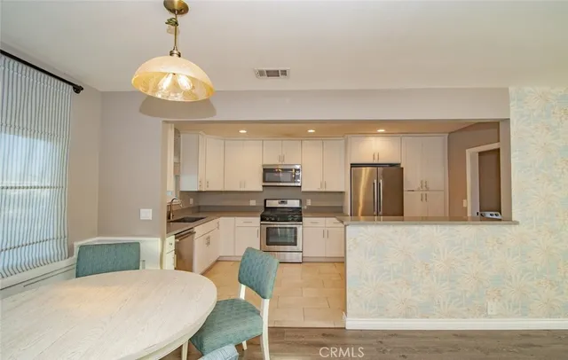 a kitchen with stainless steel appliances granite countertop a sink and microwave