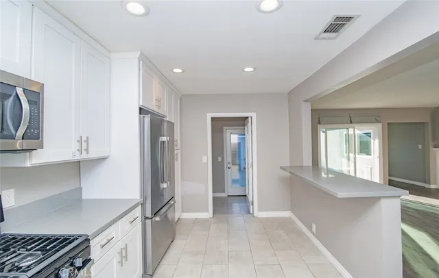 a view of a kitchen with a stove and a window