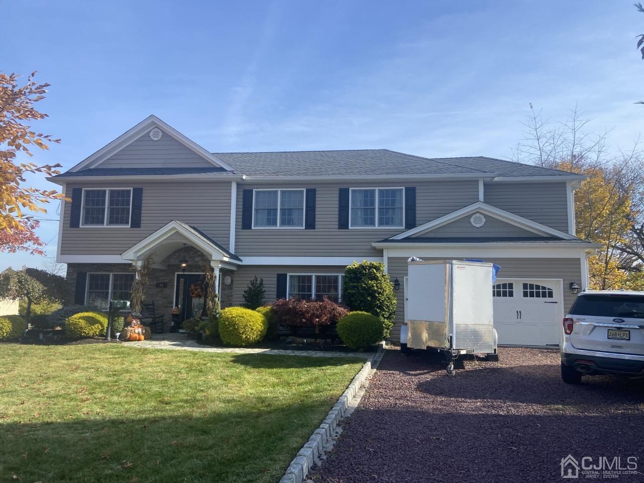 56 Kingsley Road Kendall Park, NJ 08824 - Photo 2 of 62 a front view of a house with a yard