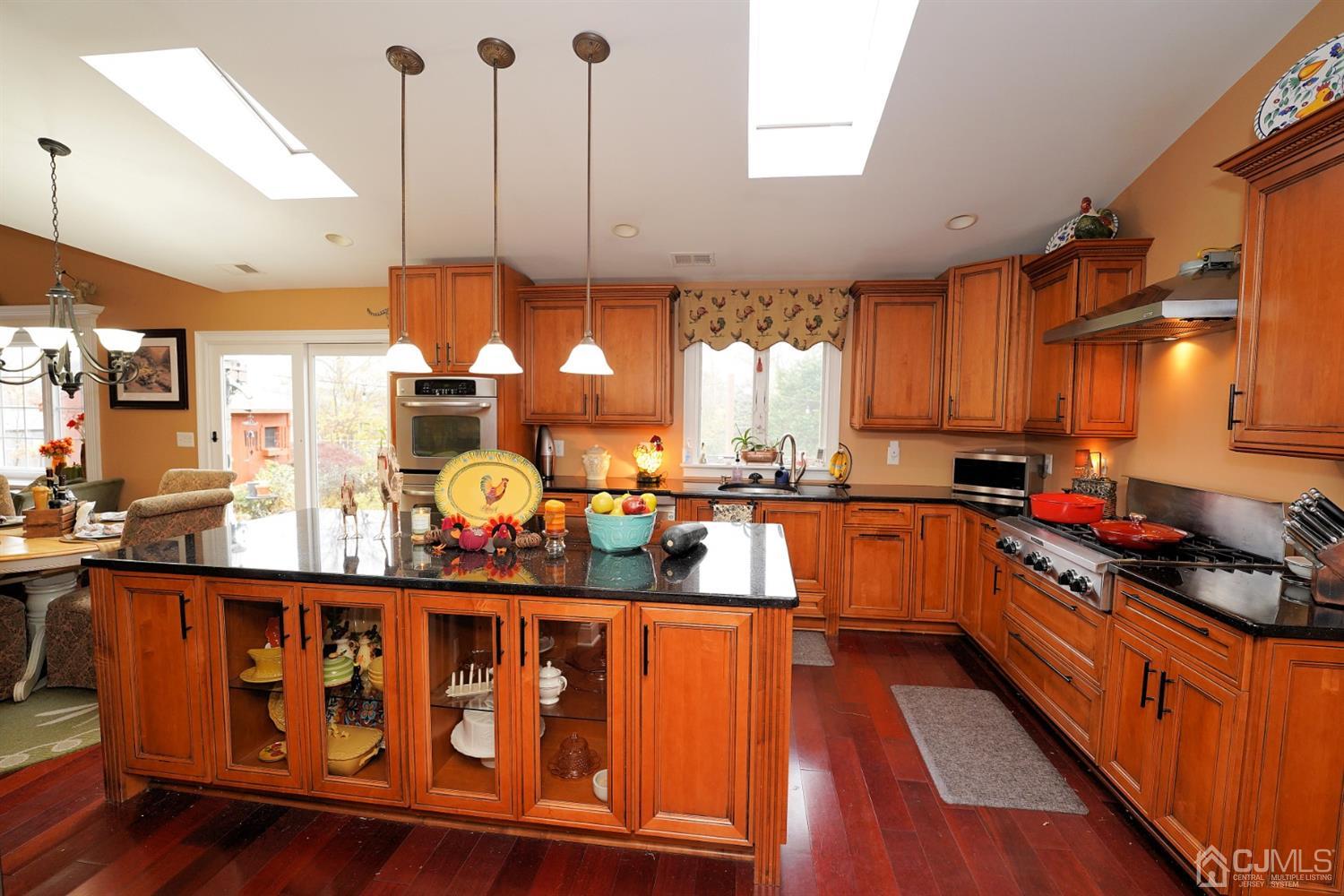56 Kingsley Road Kendall Park, NJ 08824 - Photo 16 of 62 a kitchen with stainless steel appliances granite countertop a stove a sink and a refrigerator