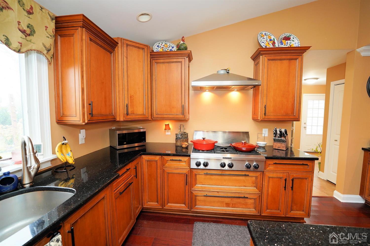 56 Kingsley Road Kendall Park, NJ 08824 - Photo 19 of 62 a kitchen with stainless steel appliances a sink window and cabinets