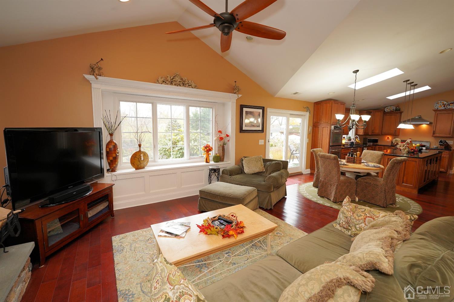 56 Kingsley Road Kendall Park, NJ 08824 - Photo 30 of 62 a living room with furniture and a flat screen tv