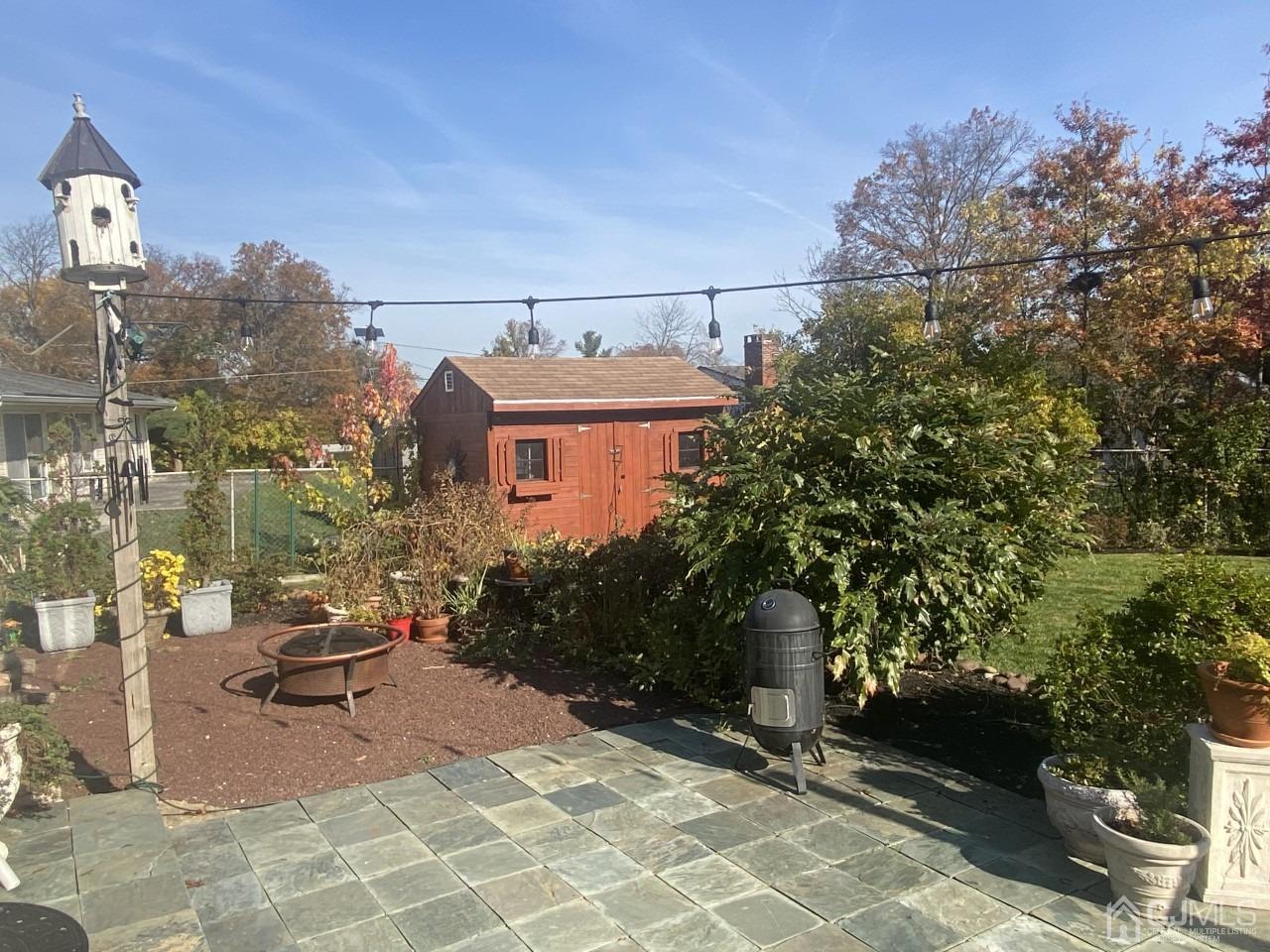 56 Kingsley Road Kendall Park, NJ 08824 - Photo 4 of 62 a view of a patio with table and chairs and potted plants