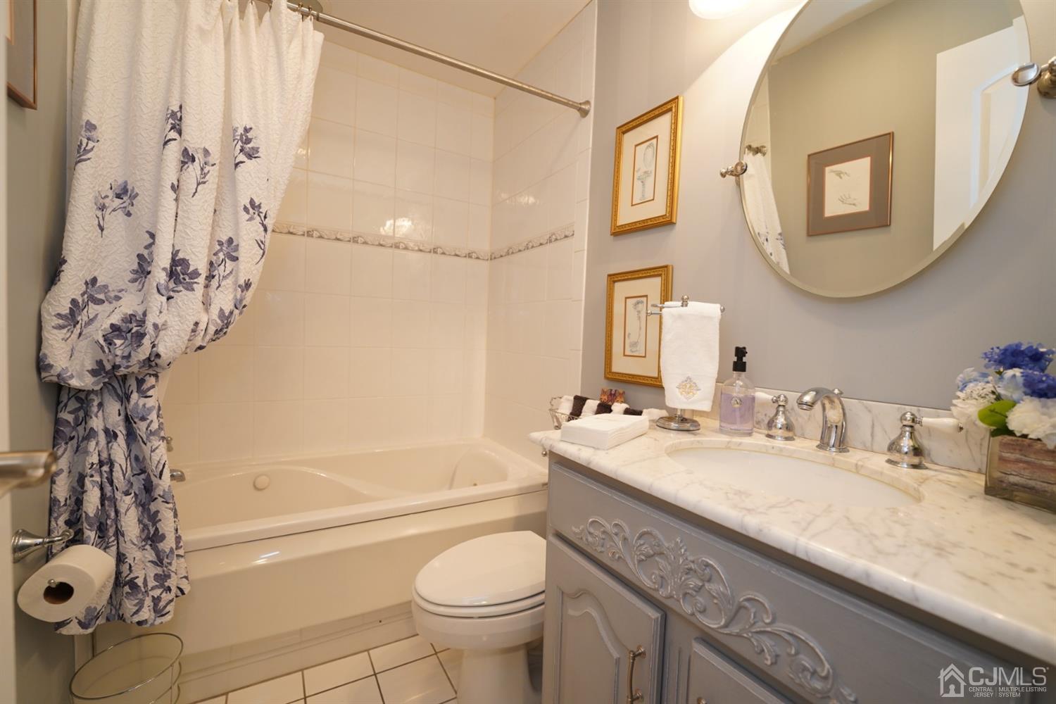 56 Kingsley Road Kendall Park, NJ 08824 - Photo 33 of 62 a bathroom with a granite countertop sink a toilet and a bathtub