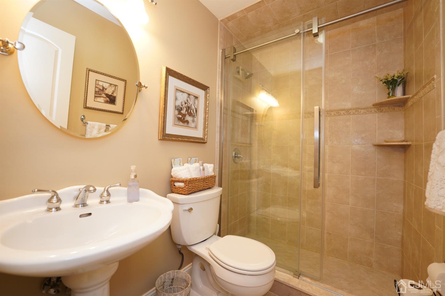 56 Kingsley Road Kendall Park, NJ 08824 - Photo 34 of 62 a bathroom with a sink toilet and shower