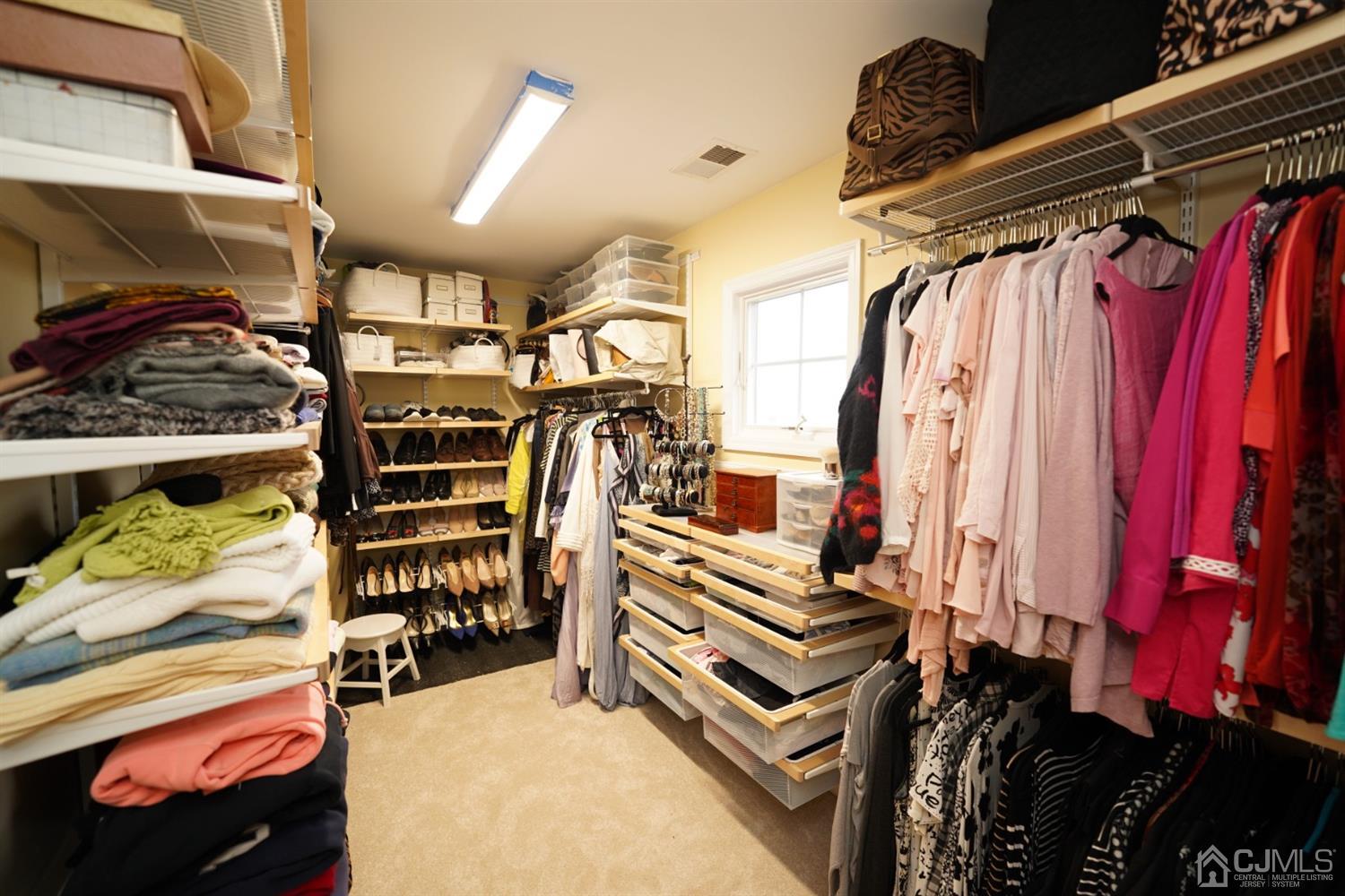 56 Kingsley Road Kendall Park, NJ 08824 - Photo 43 of 62 a view of walk in closet with clothes and shoes