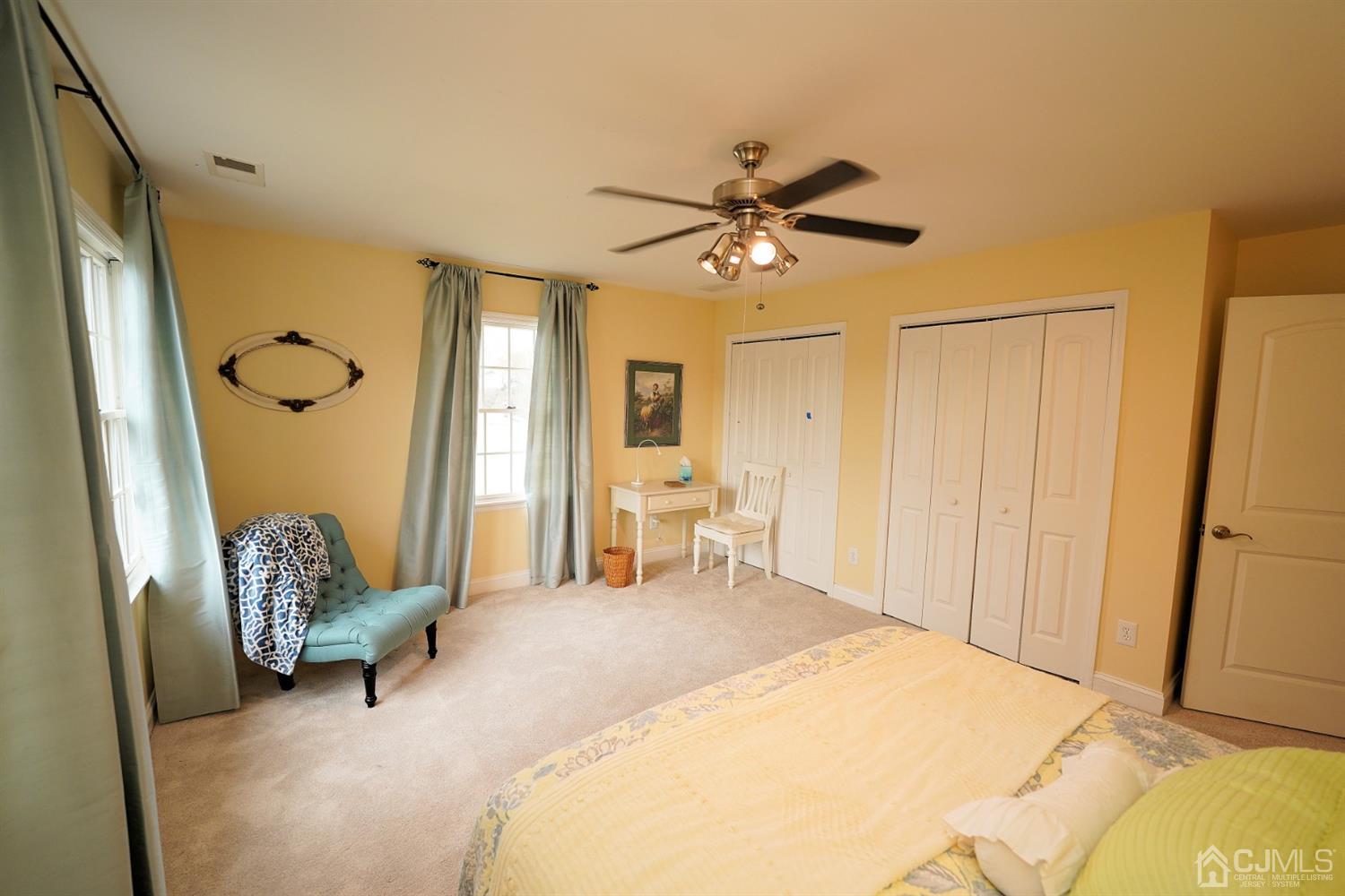 56 Kingsley Road Kendall Park, NJ 08824 - Photo 50 of 62 a living room with a bed furniture and a chandelier