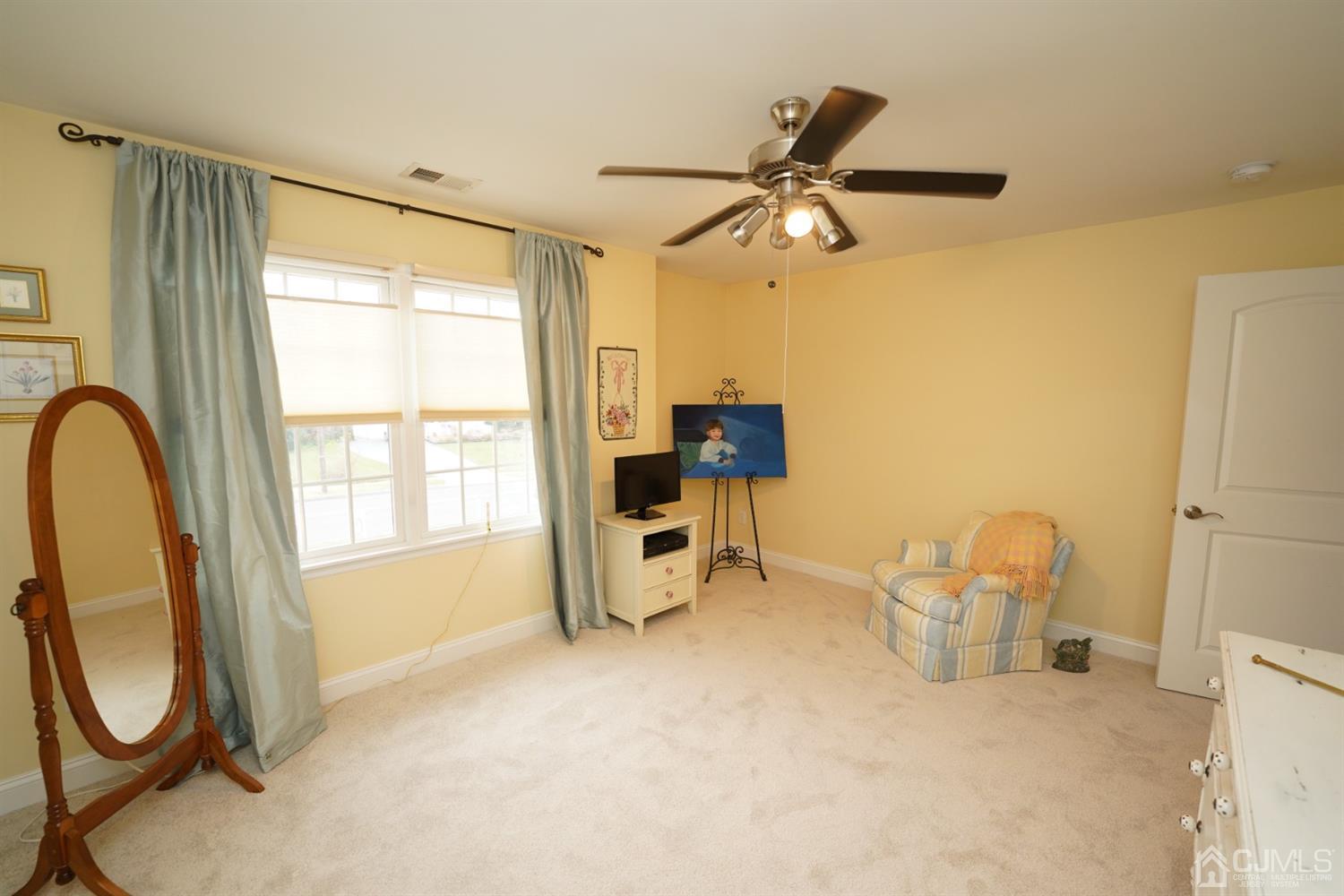 56 Kingsley Road Kendall Park, NJ 08824 - Photo 52 of 62 a view of a room with gym equipment and a window