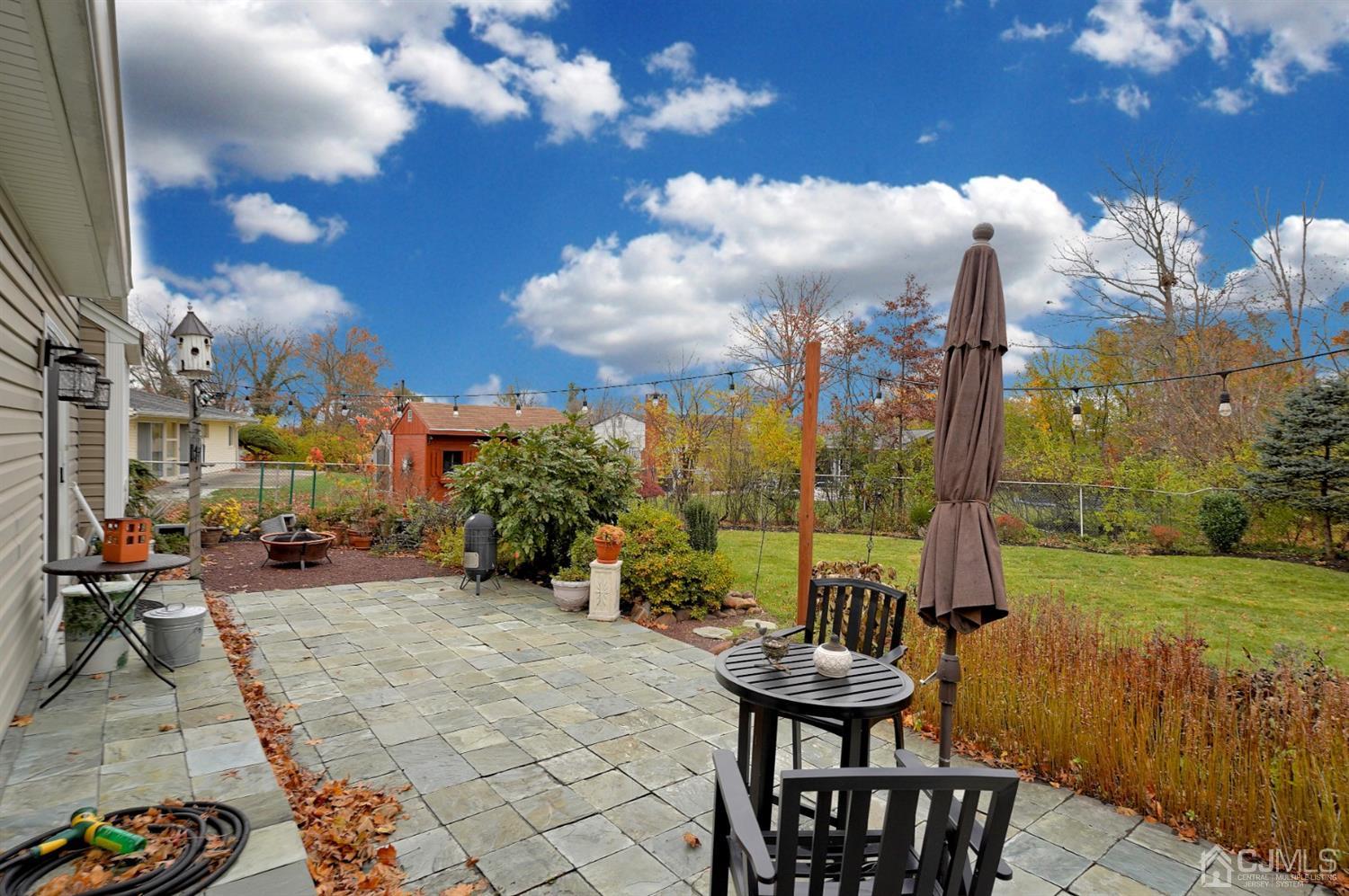 56 Kingsley Road Kendall Park, NJ 08824 - Photo 60 of 62 a view of a patio with a table and chairs and potted plants