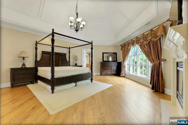 a spacious bedroom with a bed and a window