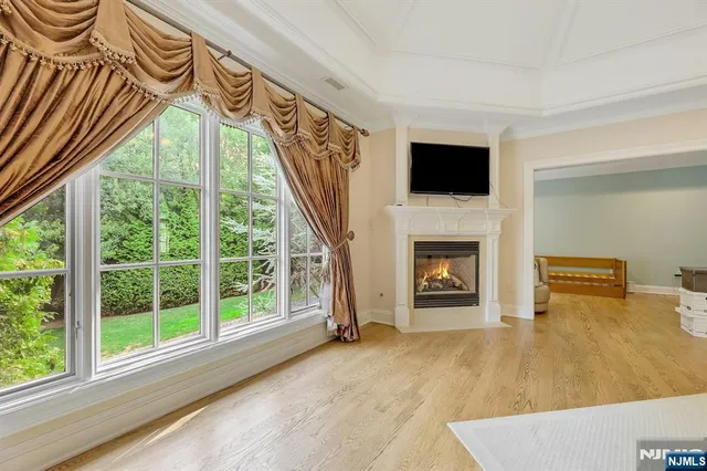 a hallway with a fireplace and a flat screen tv