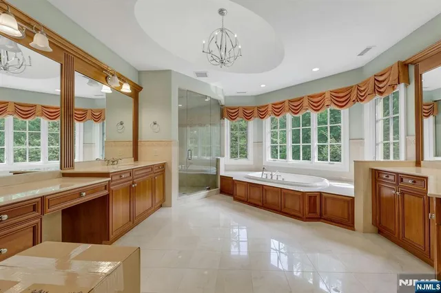 a large kitchen with kitchen island granite countertop a large window and stainless steel appliances