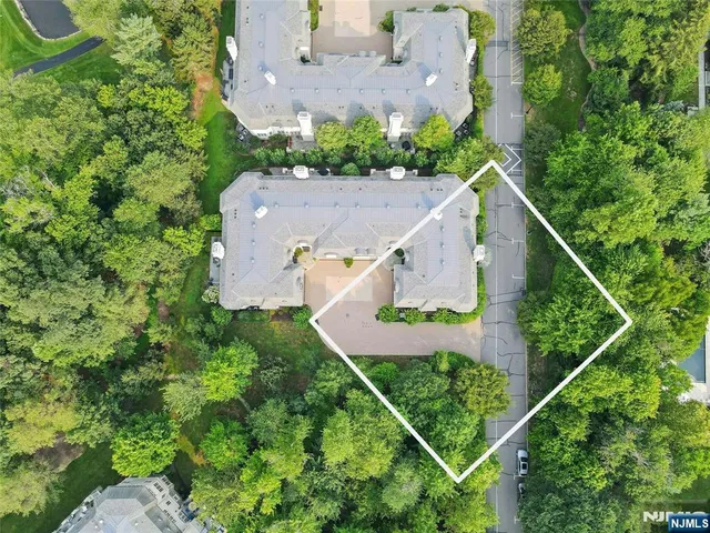 an aerial view of house with a yard and swimming pool
