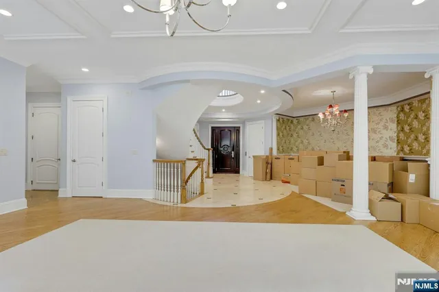 a spacious bedroom with a bed and glass door