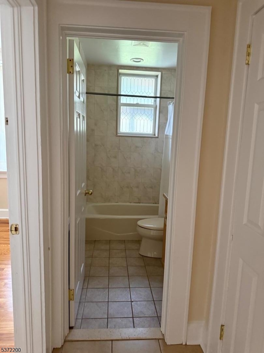 22 Baldwin Street, Unit 1 Montclair, NJ 07042 - Photo 17 of 22 a bathroom with a glass door shower a toilet and a sink