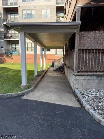 a view of a porch with furniture and garden