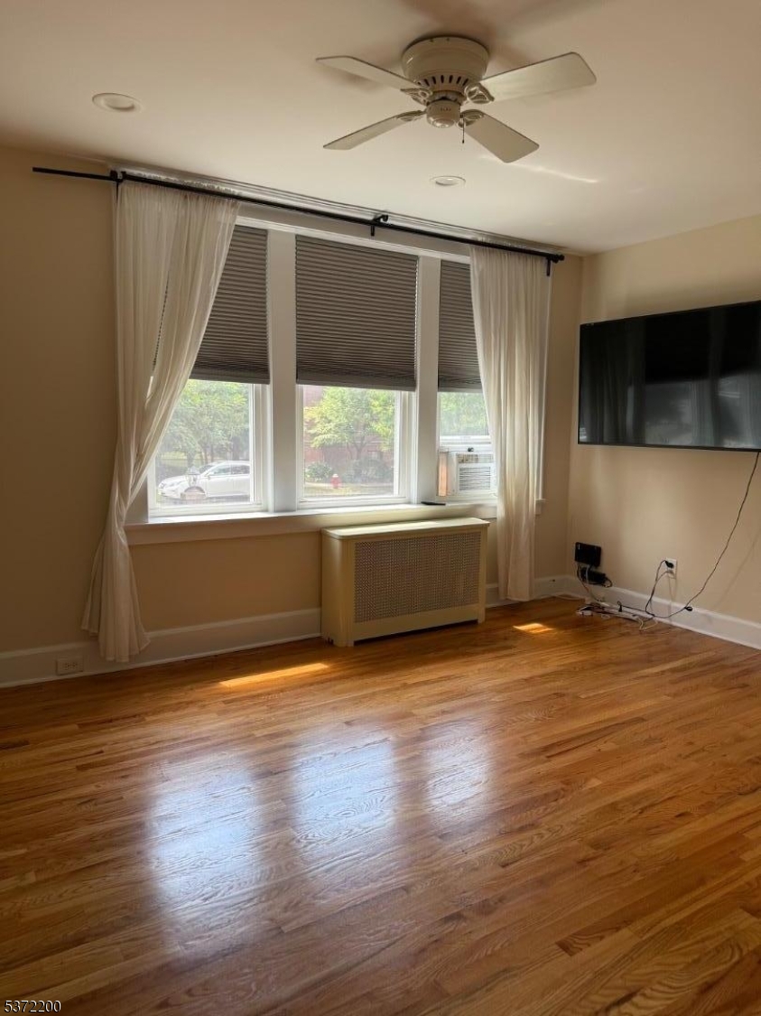 22 Baldwin Street, Unit 1 Montclair, NJ 07042 - Photo 7 of 22 an empty room with wooden floor and windows