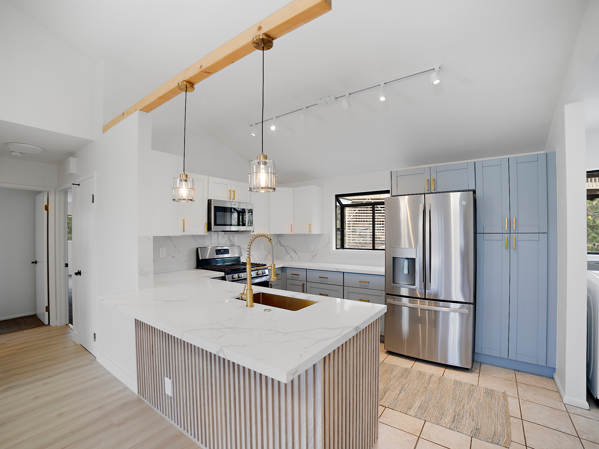 a kitchen with stainless steel appliances a refrigerator and a sink