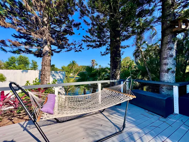 a view of a porch with furniture and garden