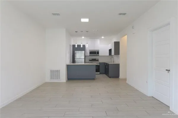 a kitchen with stainless steel appliances a refrigerator and a sink