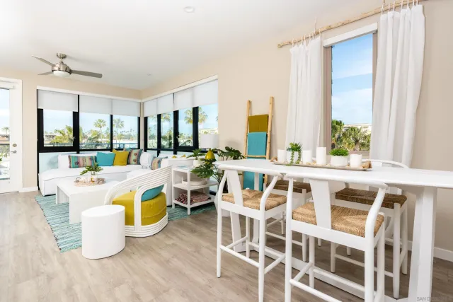 a view of a dining room with furniture a chandelier and wooden floor