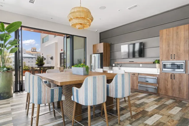 a kitchen with a table chairs sink and cabinets