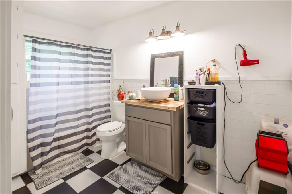 1300 Antone Street, Unit B Bryan, TX 77803 - Photo 6 of 7 a bathroom with a sink toilet and shower