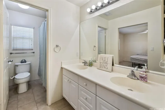 a bathroom with a toilet a sink and a mirror
