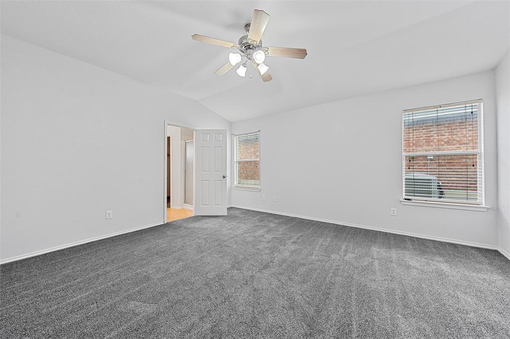 10120 Salem Way Waco, TX 76708 - Photo 13 of 19 Unfurnished room with vaulted ceiling, light carpet, and a ceiling fan