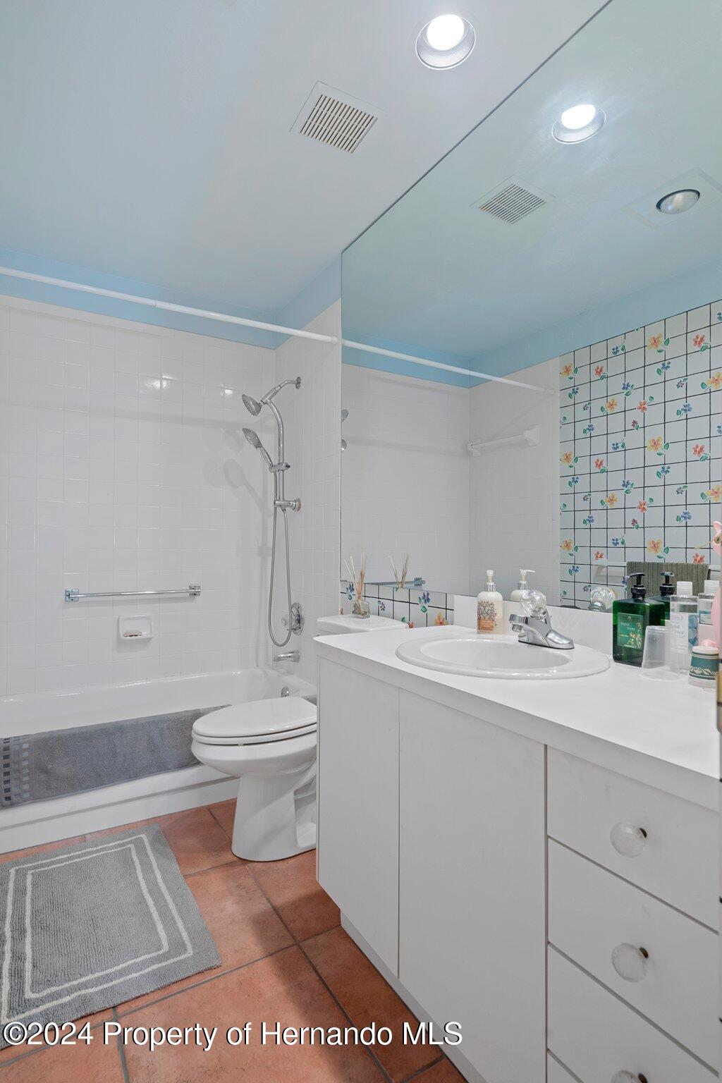 3160 Whispering Pines Court Spring Hill, FL 34606 - Photo 22 of 37 a bathroom with a sink a toilet and shower