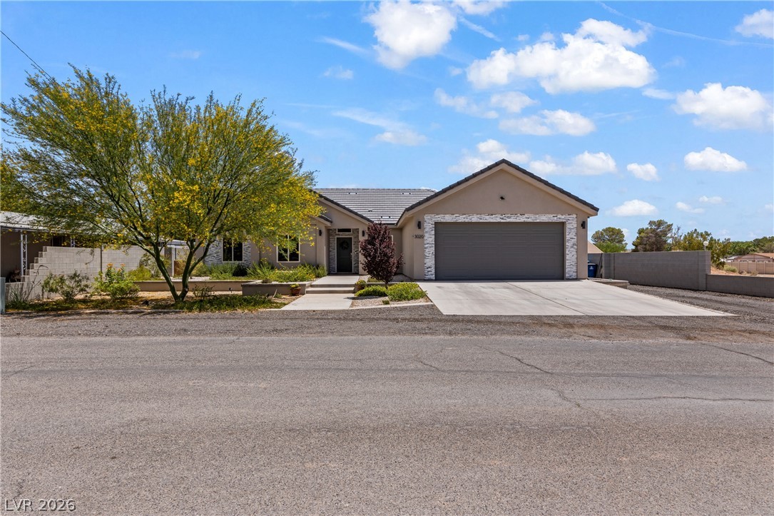 3020 Hannig Street Logandale, NV 89021 - Photo 68 of 75 A well-maintained facade with modern stonework and a wide driveway presents a welcoming curb appeal.