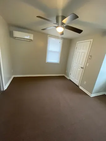 en empty room with windows and entrance