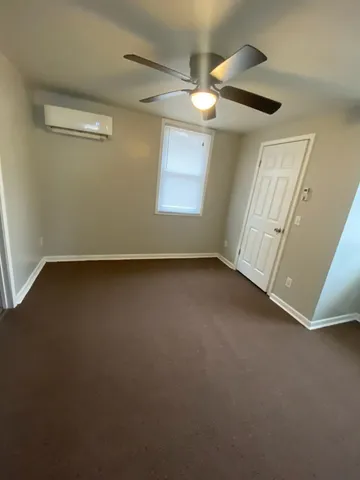 en empty room with windows and entrance