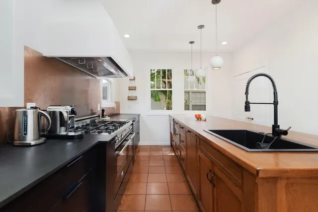 a kitchen with granite countertop a sink and cabinets