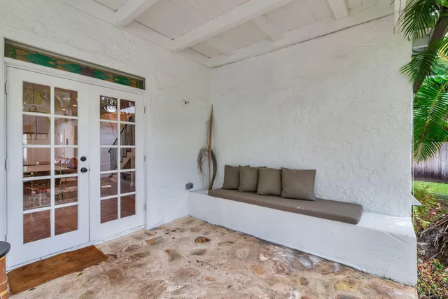 a living room with a couch and a potted plant