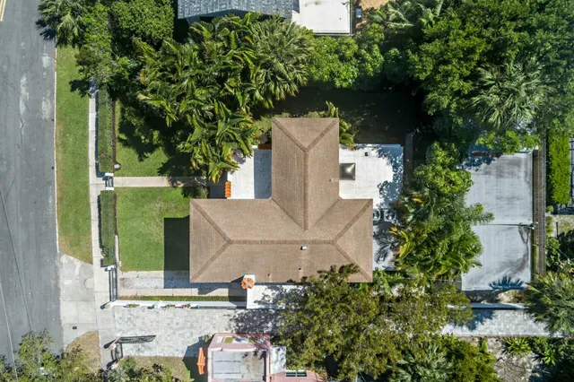 an aerial view of a house with a yard