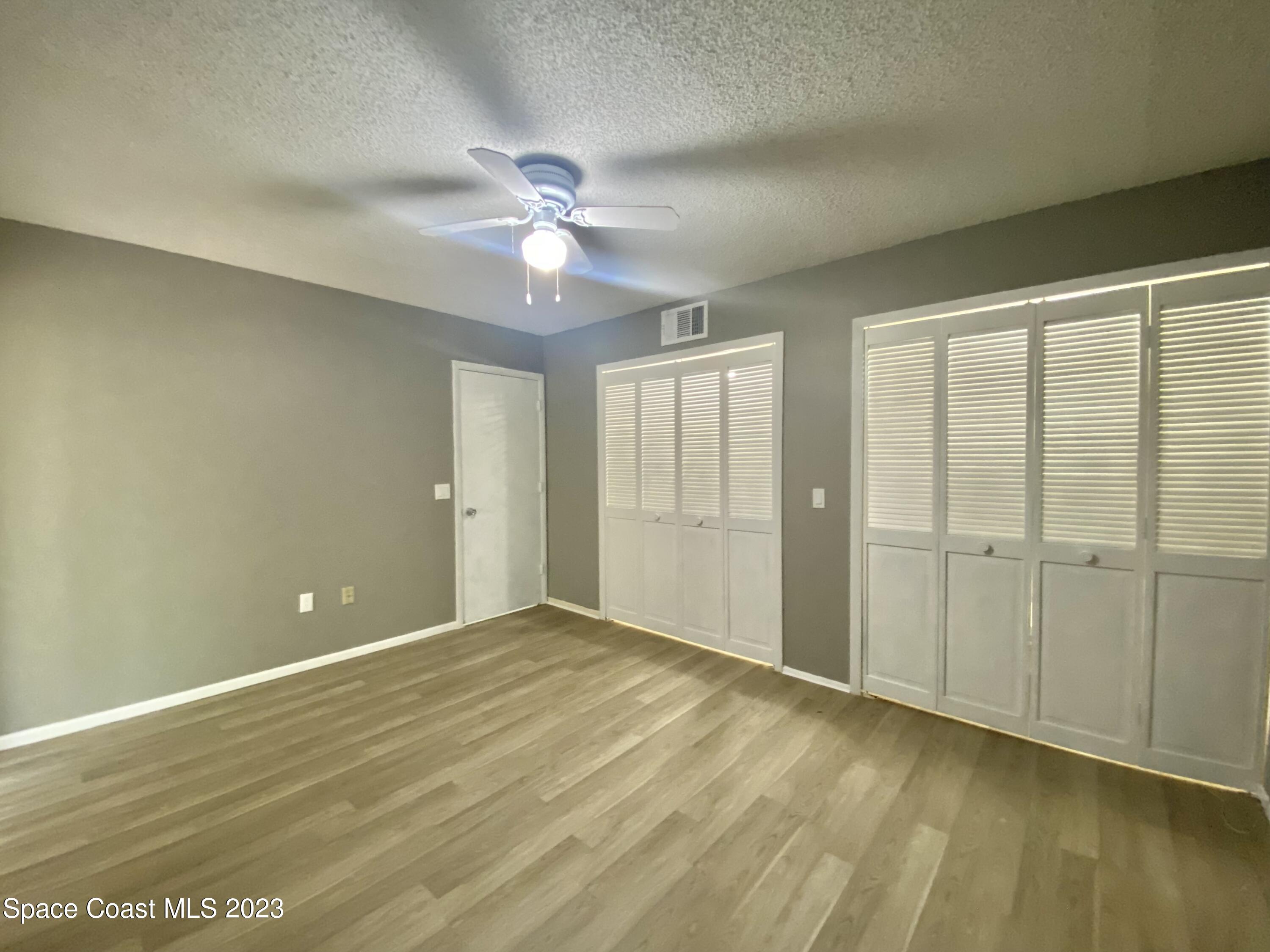 664 Cedar Side Circle Northeast Palm Bay, FL 32905 - Photo 12 of 20 wooden floor in an empty room with a window