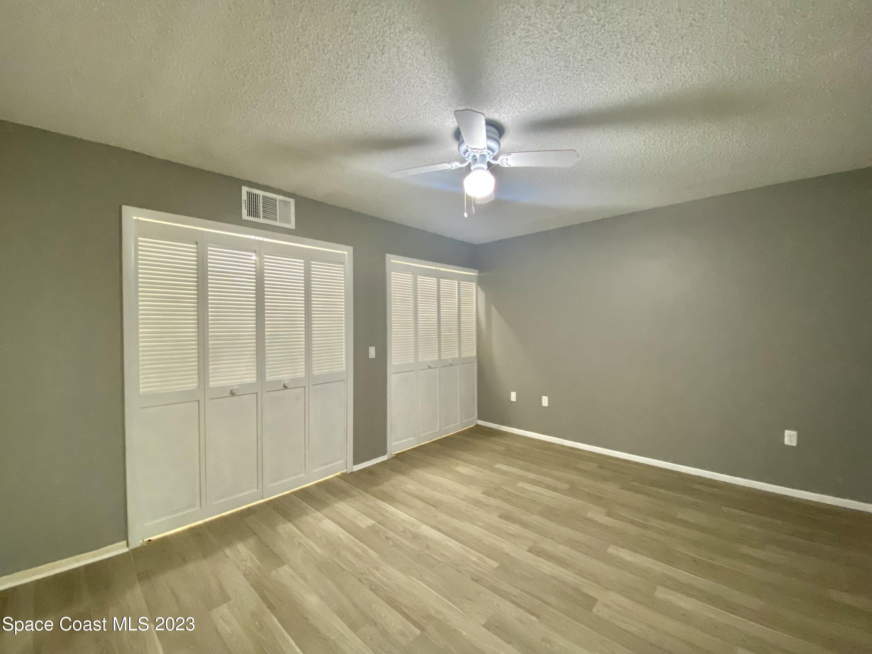 664 Cedar Side Circle Northeast Palm Bay, FL 32905 - Photo 13 of 20 an empty room with a ceiling fan and a window
