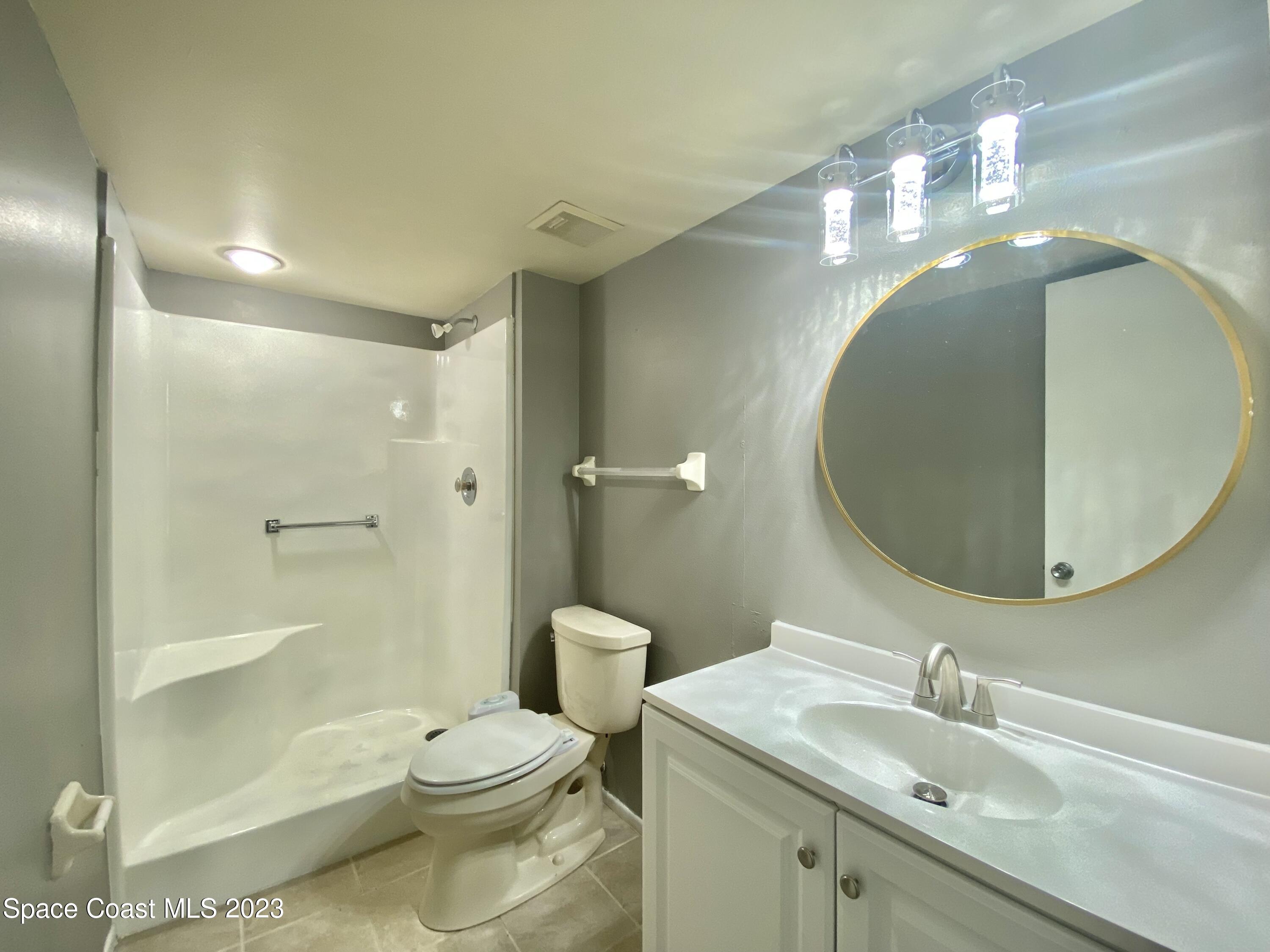 664 Cedar Side Circle Northeast Palm Bay, FL 32905 - Photo 15 of 20 a bathroom with a sink a toilet and shower