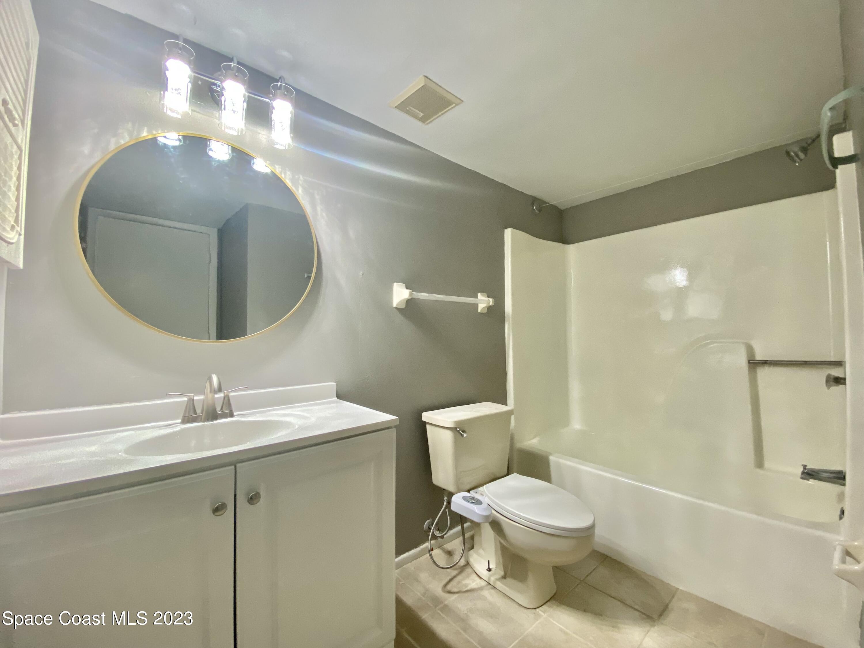 664 Cedar Side Circle Northeast Palm Bay, FL 32905 - Photo 16 of 20 a bathroom with a sink and a mirror