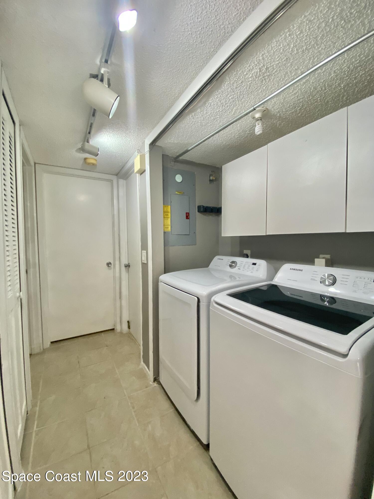 664 Cedar Side Circle Northeast Palm Bay, FL 32905 - Photo 18 of 20 a utility room with dryer and washer