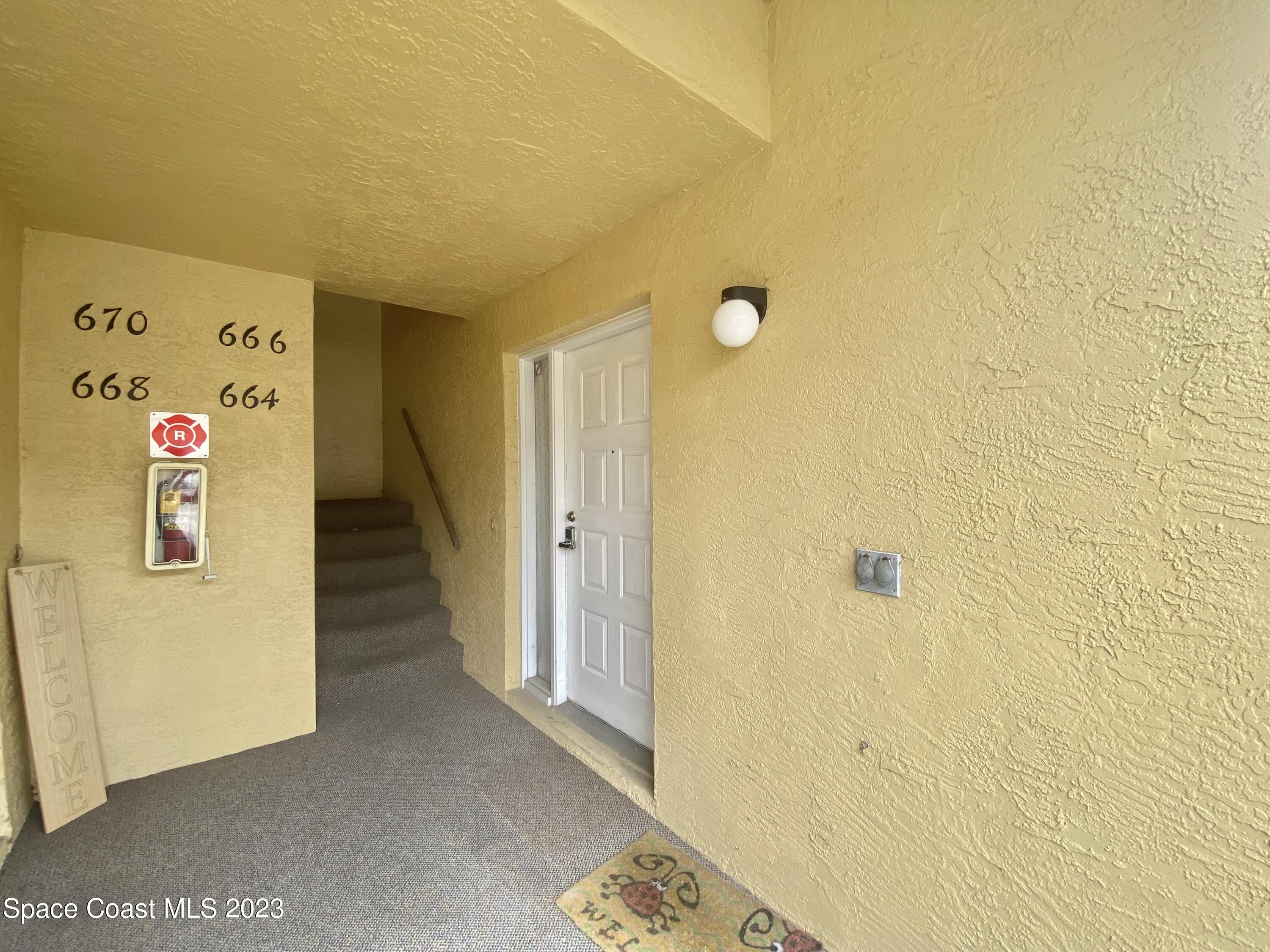 664 Cedar Side Circle Northeast Palm Bay, FL 32905 - Photo 2 of 20 a view of a hallway with elevator