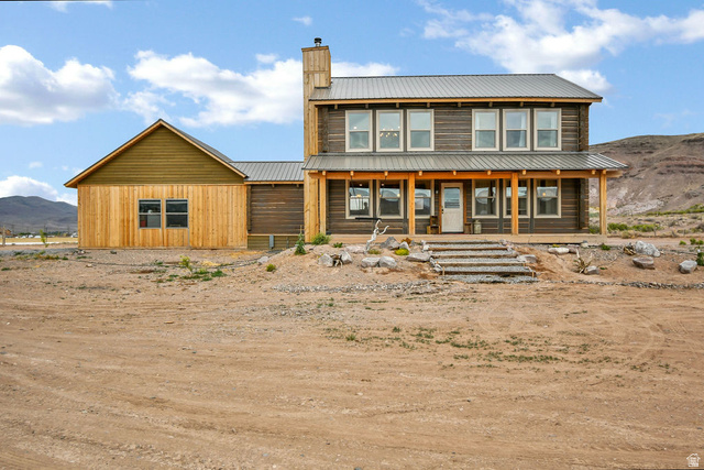 544 East 600 North, Unit 1 Joseph, UT 84739 - Photo 1 of 65 Two-story residence featuring a metal roof, wood siding, and an expansive covered front porch with supporting columns